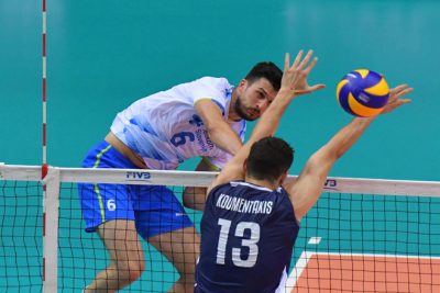 Mitja Gasparini of Slovenia spikes against Rafail Koumentakis of Greece